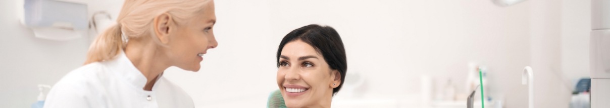 Claremore dental team member smiling while talking to patient
