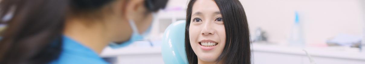 Young woman talking to her Claremore dentist