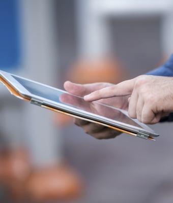 Person typing on a tablet
