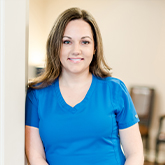 Smiling Claremore dental team member Lindsey in blue scrubs