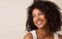 Young woman smiling while looking off to the side