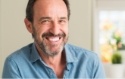 Smiling man in denim shirt