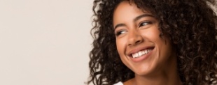 Young woman smiling and looking off to the side