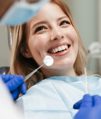Woman smiling at her dentist during dental checkup