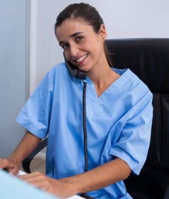 Smiling dental team member talking on the phone