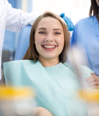 Young woman grinning in dental chair
